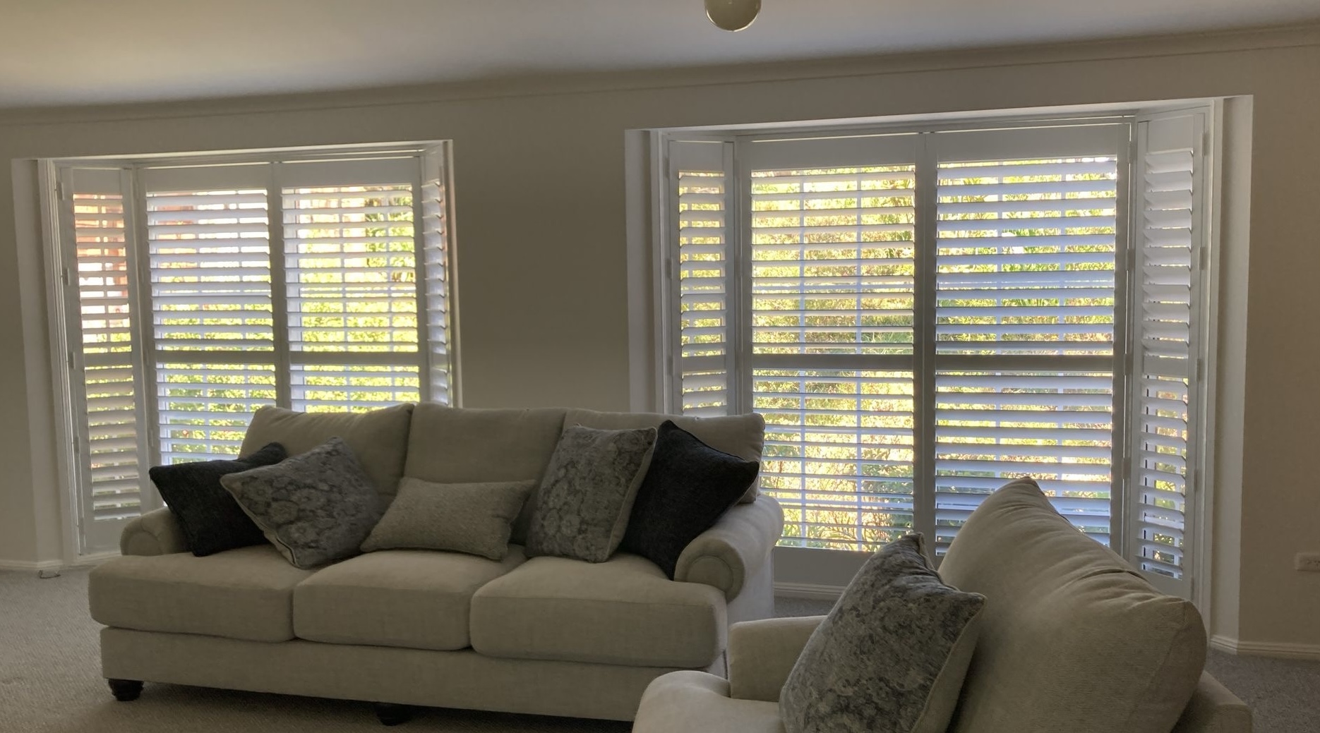 Plantation shutter installation on bay window